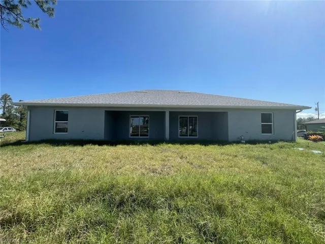 Rear view of property with stucco siding