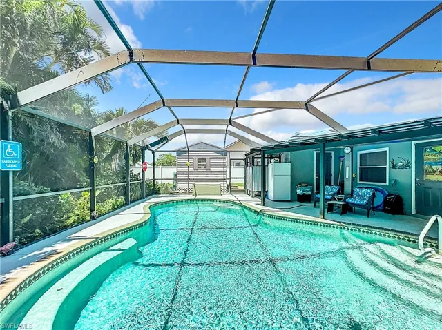 Outdoor pool featuring a lanai and a patio area