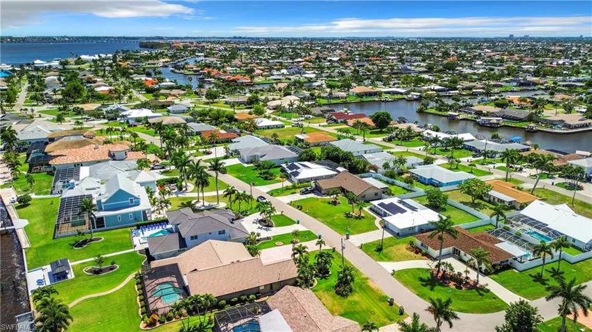 Birds eye view of property with a water view and a residential view