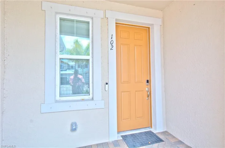 Entrance to property featuring stucco siding