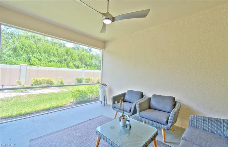 Sunroom featuring a patio area and ceiling fan