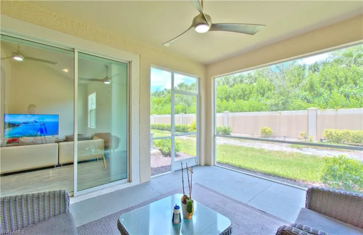 Sunroom / solarium featuring ceiling fan