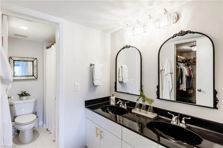 Bathroom with vanity, toilet, and tile patterned floors