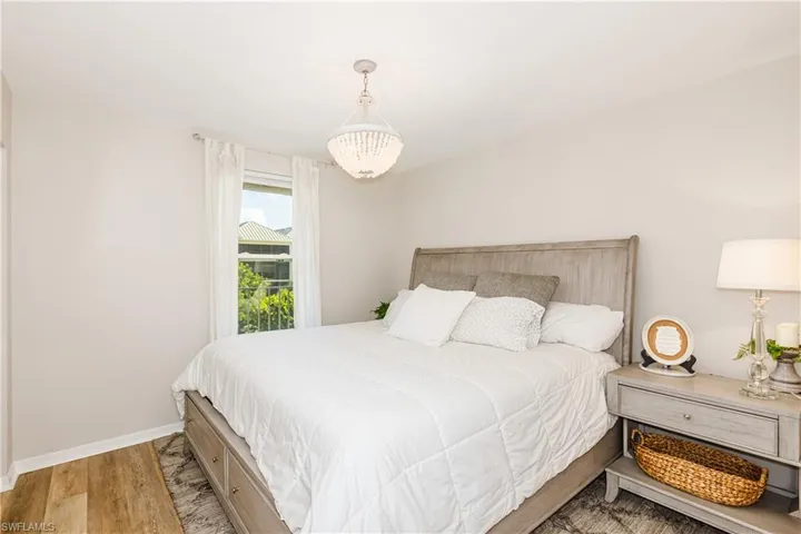 Bedroom featuring light wood-type flooring and a chandelier