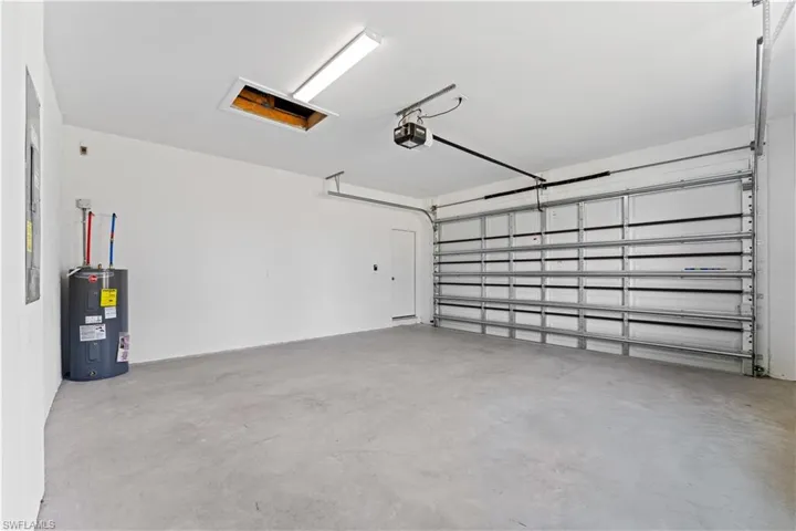 Garage with electric water heater and a garage door opener