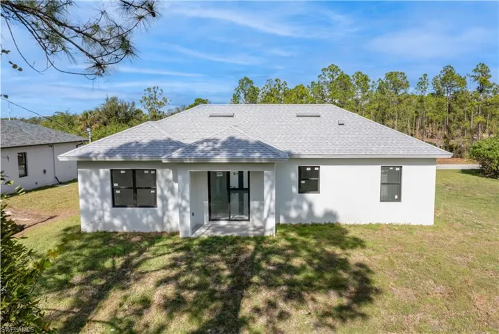 Rear view of property featuring a patio area and a yard