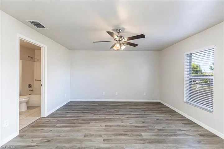 Unfurnished room featuring light wood finished floors and ceiling fan