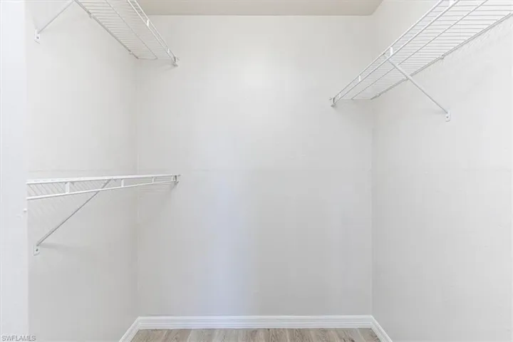 Spacious closet with light wood-style floors