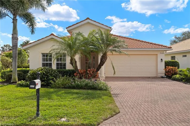 View of front of home with a garage, a tiled roof, decorative driveway, stucco siding, and a front yard