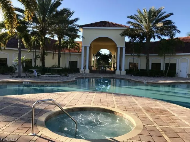 Community pool featuring a patio area and a hot tub