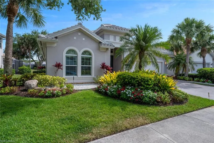Mediterranean / spanish-style house featuring a front lawn, and attached 2 car garage