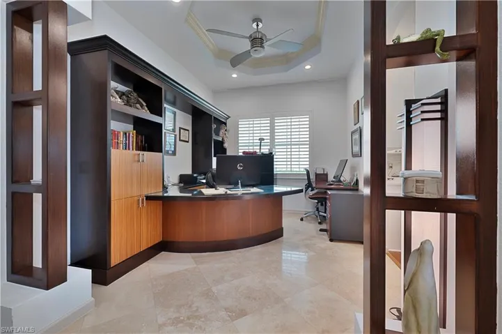Office featuring a ceiling fan, ornamental molding, a tray ceiling, and recessed lighting