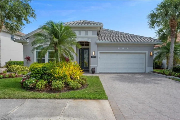Mediterranean / spanish-style house featuring a tile roof, a garage, stucco siding, and brick paver driveway