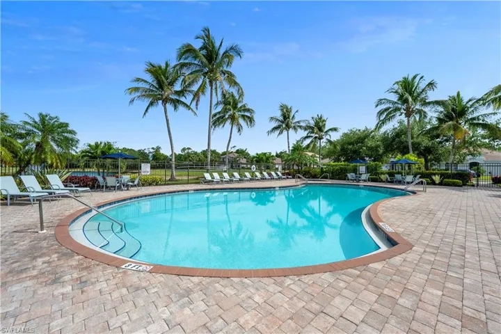 Community pool featuring fence and a patio area