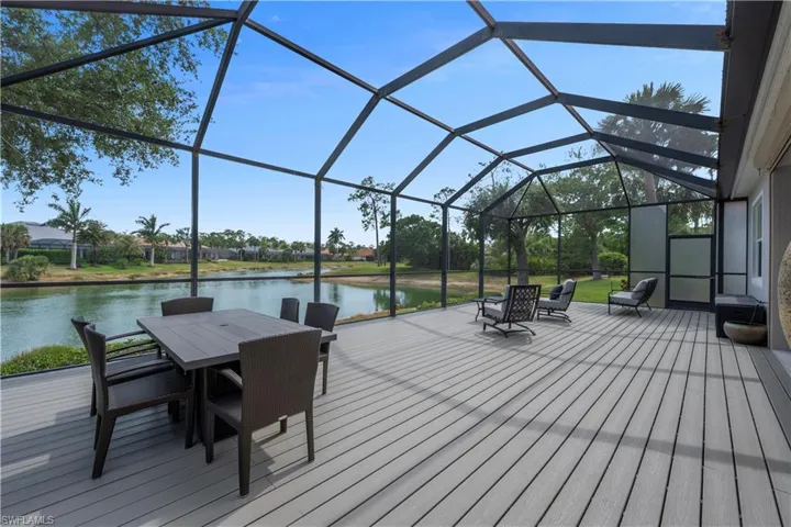 Deck with outdoor dining space, a water view, and screen enclosure