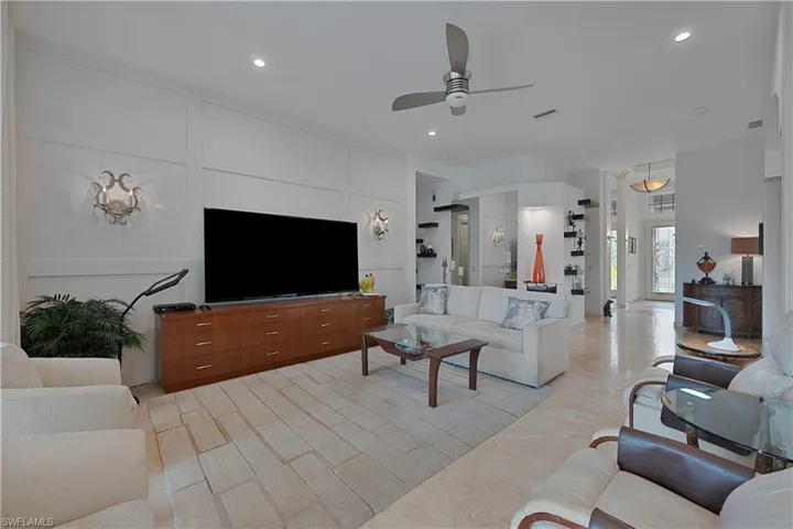 Living room with a ceiling fan and recessed lighting