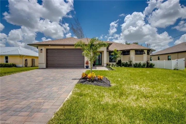 Ranch-style house with a garage and a front yard, Paver Driveway
