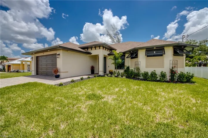 CUSTOM new Construction home with a garage and a front lawn