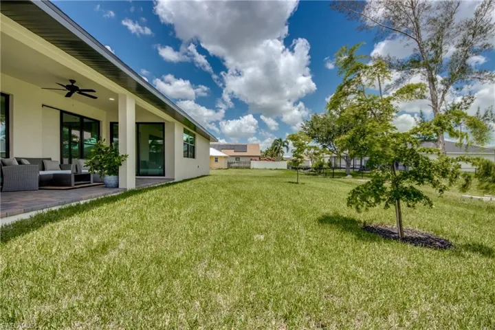 View of yard featuring an outdoor living space, a patio area, and ceiling fan