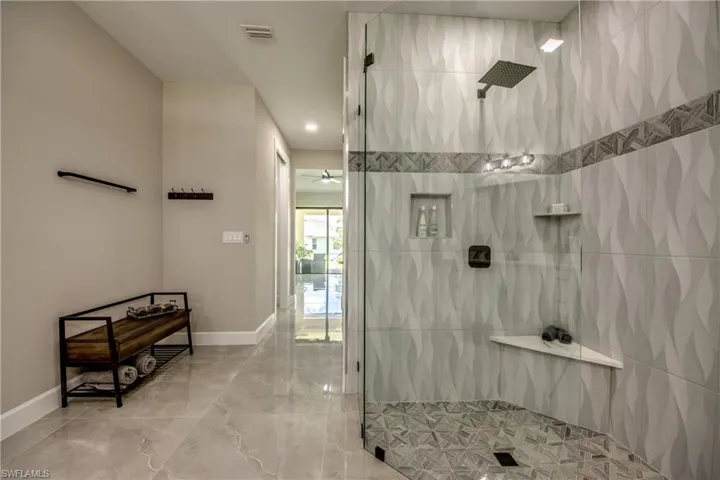 MASTER Bathroom featuring tiled shower, tile patterned floors, and tile walls WITH RAIN SHOWER!!