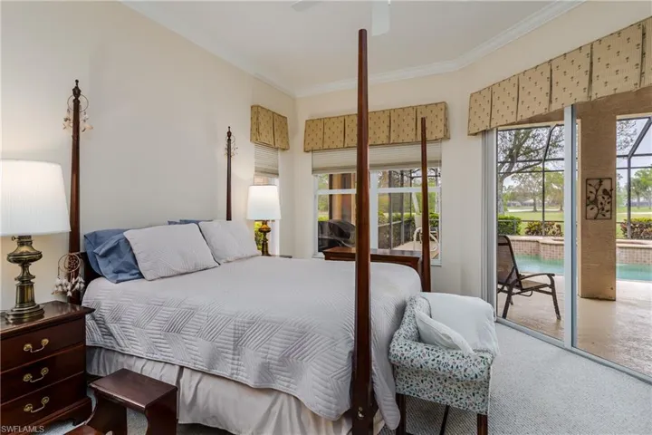 Carpeted bedroom with multiple windows, access to exterior, ceiling fan, and crown molding