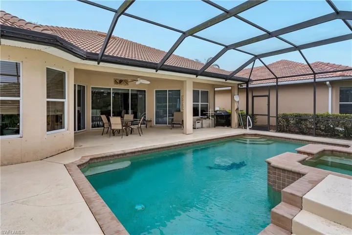 Integrated pool / hot tub with outdoor dining area, a patio area, and a sunroom