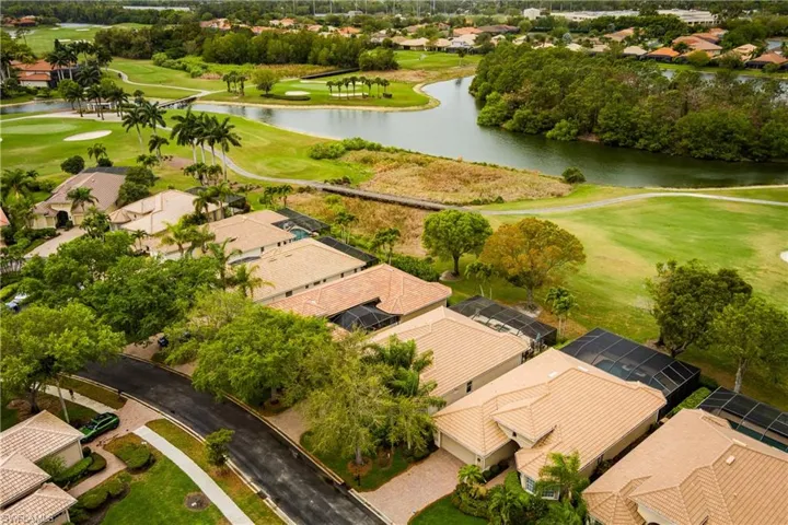Aerial perspective of suburban area with a local golf course and a nearby body of water