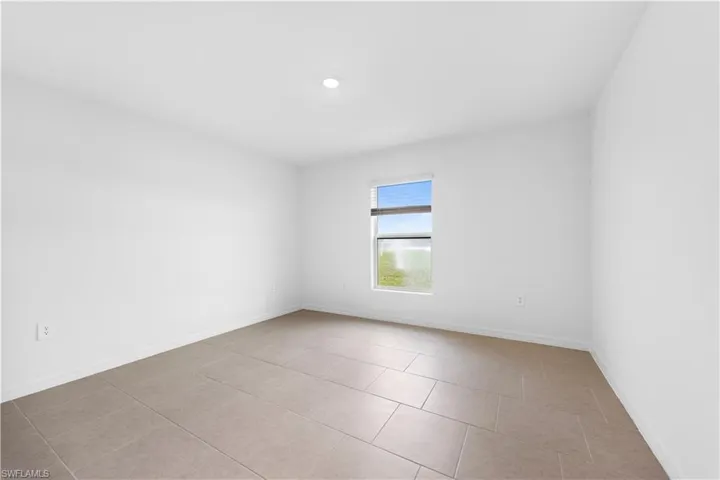 Unfurnished room with baseboards and light tile patterned floors