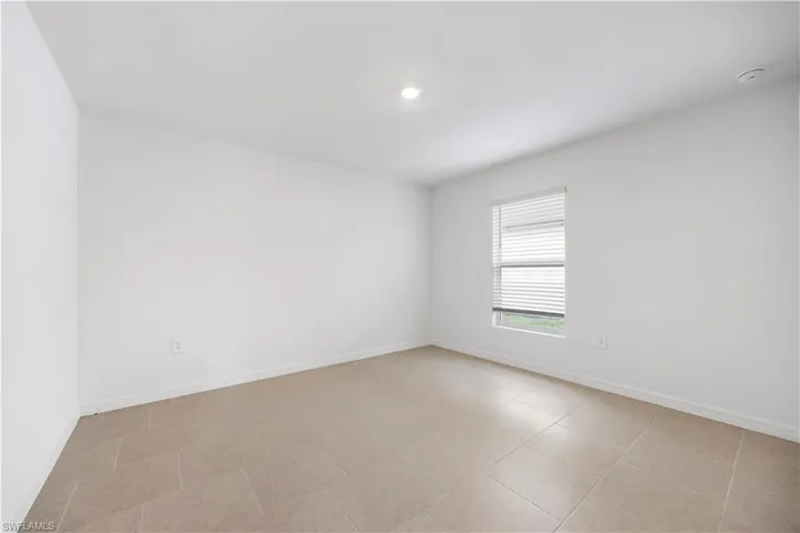 Empty room featuring baseboards