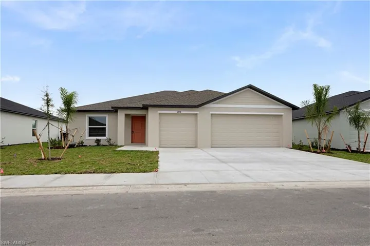 View of front of home featuring a front lawn, an attached garage, concrete driveway, roof with shingles, and stucco siding