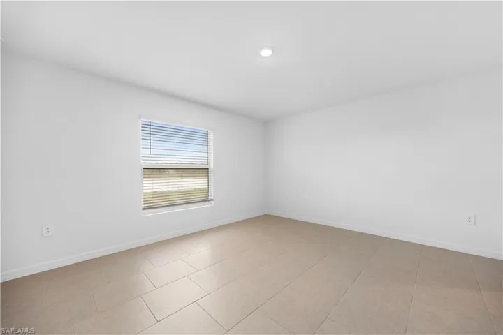 Empty room featuring baseboards
