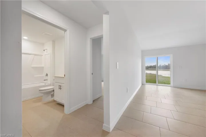 Hallway with light tile patterned flooring