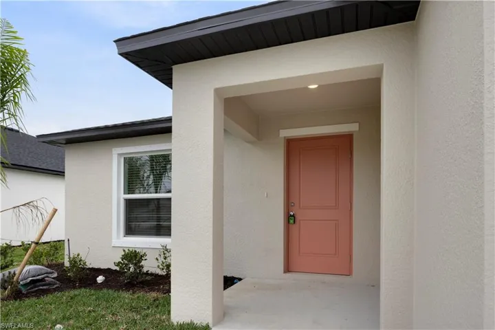 Entrance to property featuring stucco siding