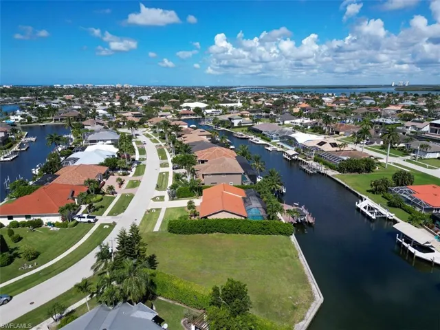 Aerial perspective of suburban area featuring a nearby body of water