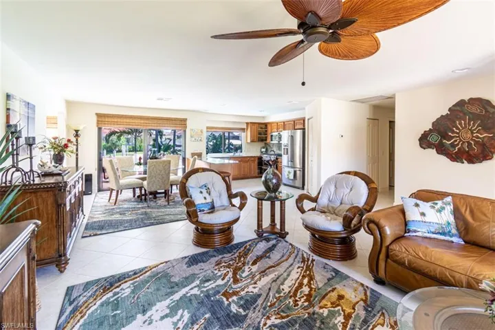 Living room with a ceiling fan and light tile patterned floors