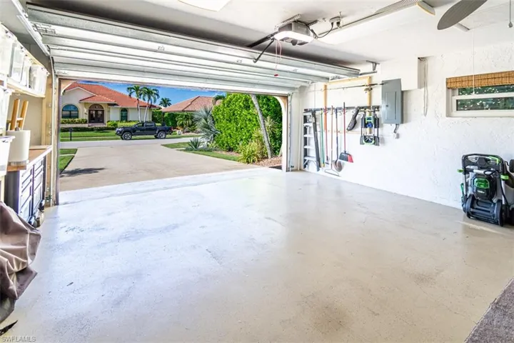 Garage featuring electric panel and a garage door opener