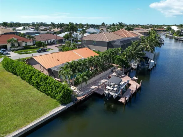 Aerial perspective of suburban area featuring a nearby body of water