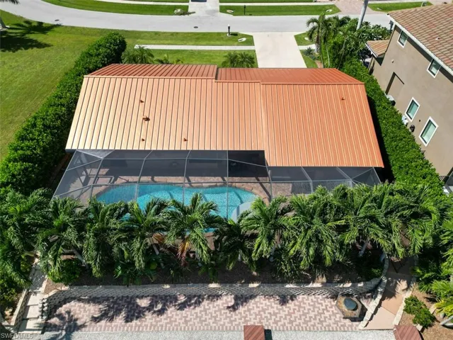 Aerial view of property and surrounding area featuring a pool area
