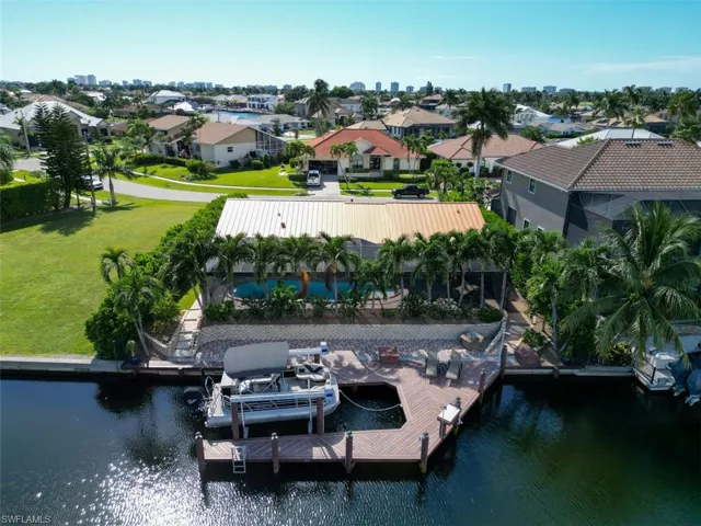 Dock area featuring a water view and a lawn
