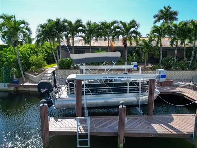 Dock area with boat lift and a water view