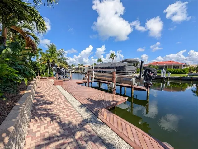 Dock area featuring boat lift and a water view