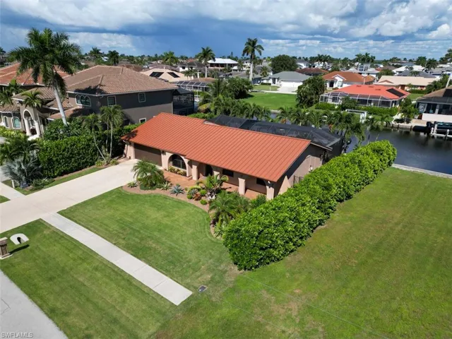 Aerial perspective of suburban area featuring a large body of water