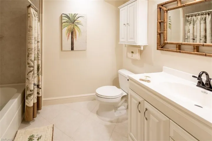 Full bathroom featuring light tile patterned flooring, shower / tub combo, and vanity
