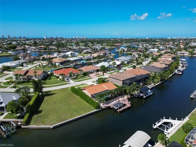 View of property location featuring a large body of water and nearby suburban area