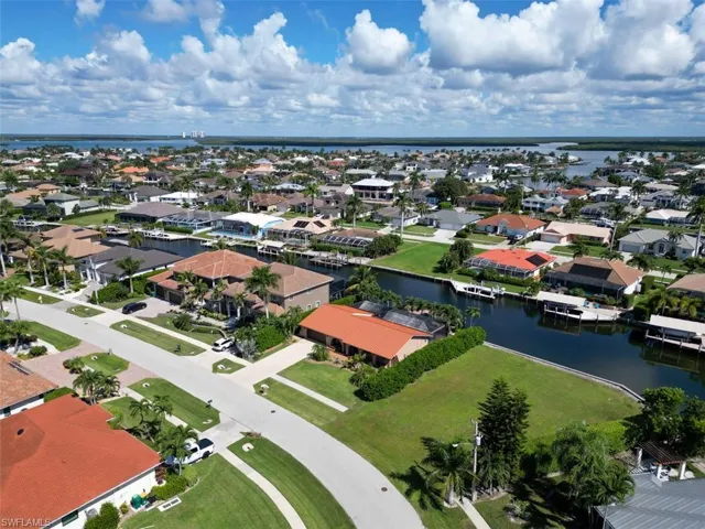 Aerial perspective of suburban area with a nearby body of water