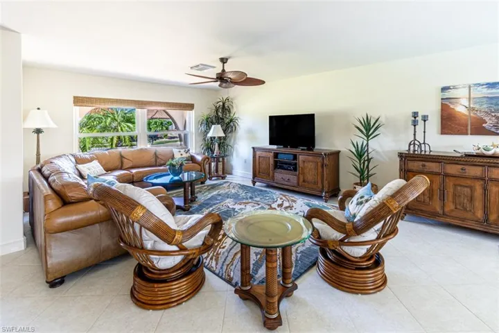 Living room featuring a ceiling fan and light tile patterned floors