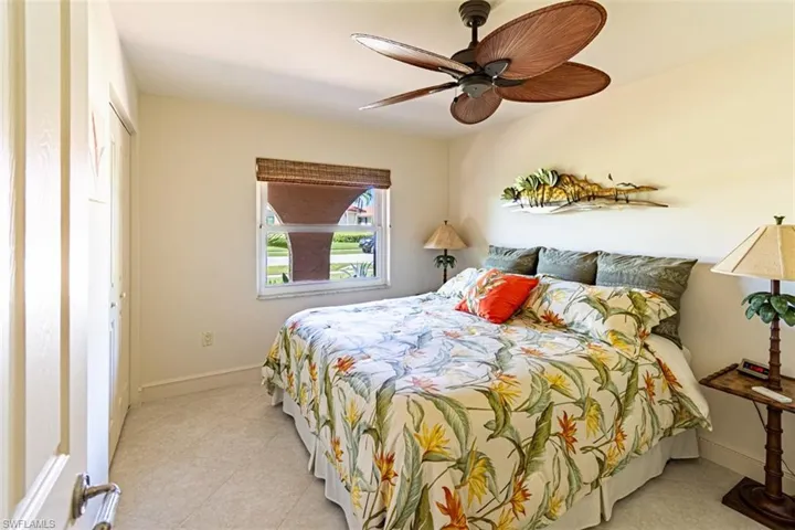 Bedroom featuring ceiling fan, a closet, and light tile patterned flooring