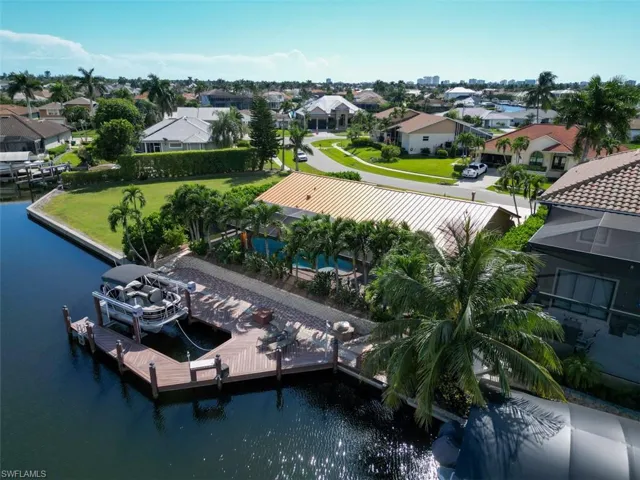 Aerial perspective of suburban area featuring a large body of water