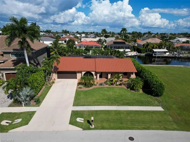 Aerial perspective of suburban area with a nearby body of water