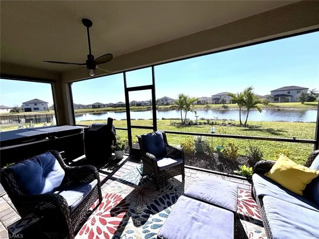 Sunroom / solarium featuring an outdoor hangout area, ceiling fan, and a residential view